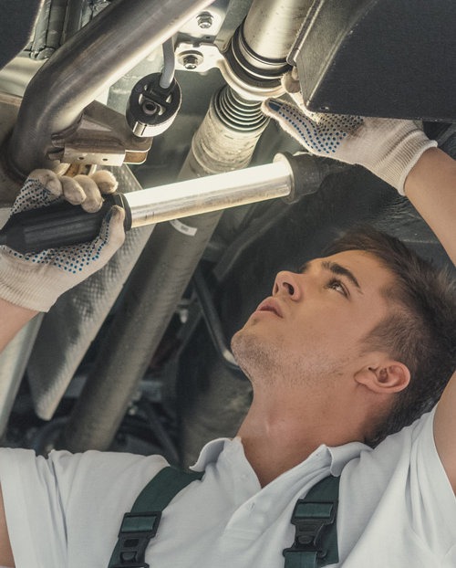 Mechanic underneath a vehicle during an inspection - Servicing, Bodywork, Crash Repairs & More | Car Garage Harrow